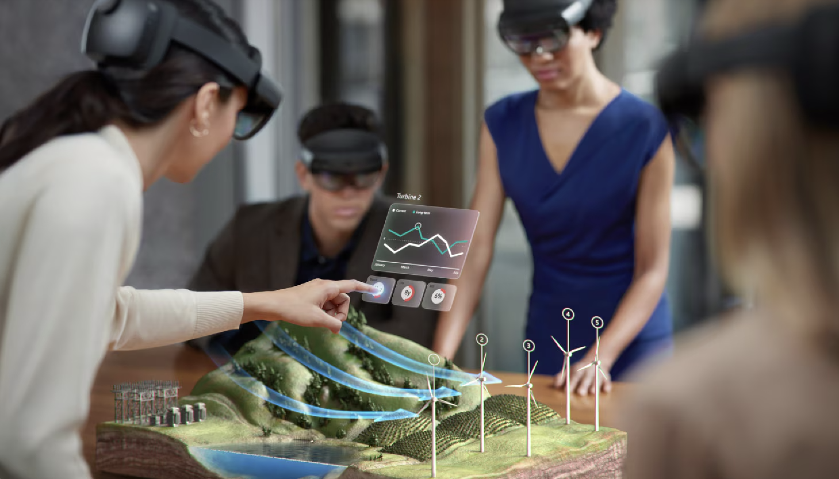  Individuals interacting with a holographic display using Microsoft HoloLens 2 data glasses