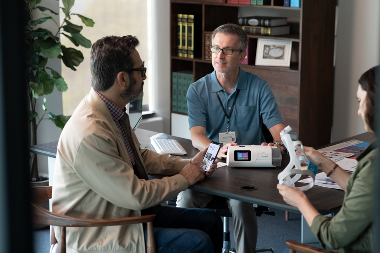 Patients in office looking at CPAP equipment