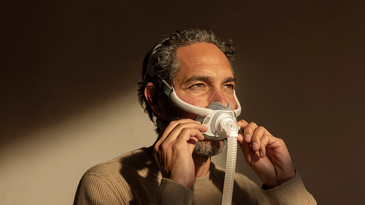Man adjusting Resmed AirTouch F40 mask